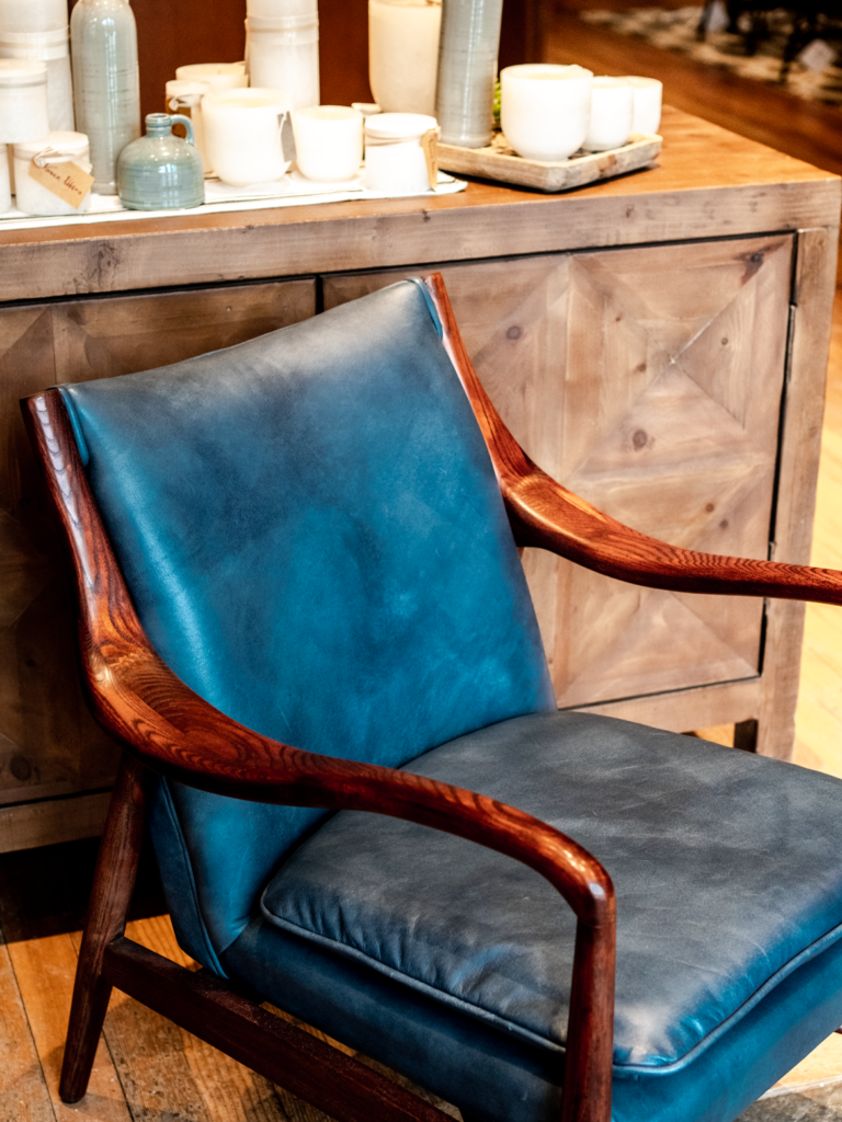 take a seat in this gorgeous blue leather chair with wood accents