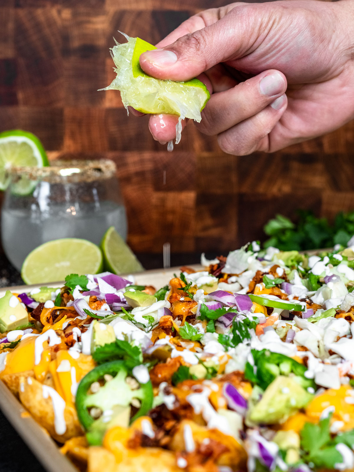 Adding lime to finish off the nachos and add an extra kick of flavor.
