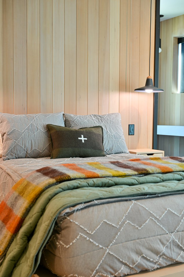 Warm blankets and subtle bedding tie together this modern yet natural Schweitzer home.