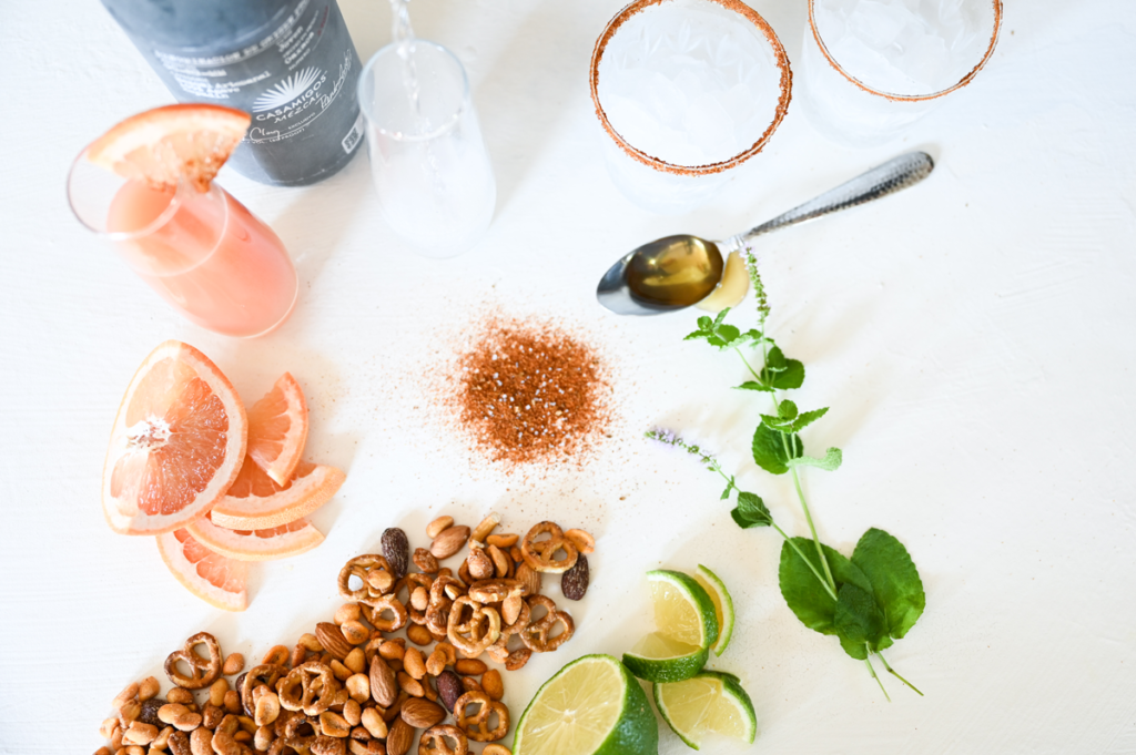 mezcal paloma drink ingredients with serving nuts to spice up the flavor